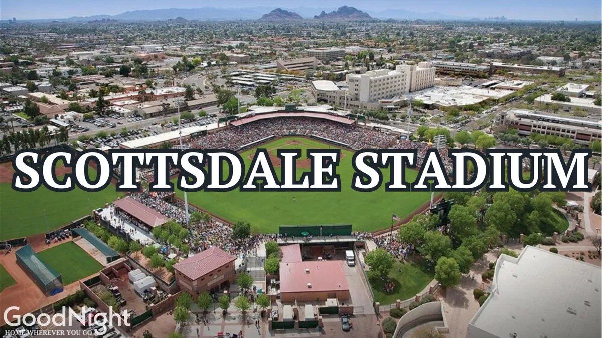 A lively exterior shot of Scottsdale Stadium, filled with spectators and featuring a vibrant green baseball field. The energy of the crowd and the outdoor setting reflect the excitement of catching an MLB Spring Training game in the neighborhood.